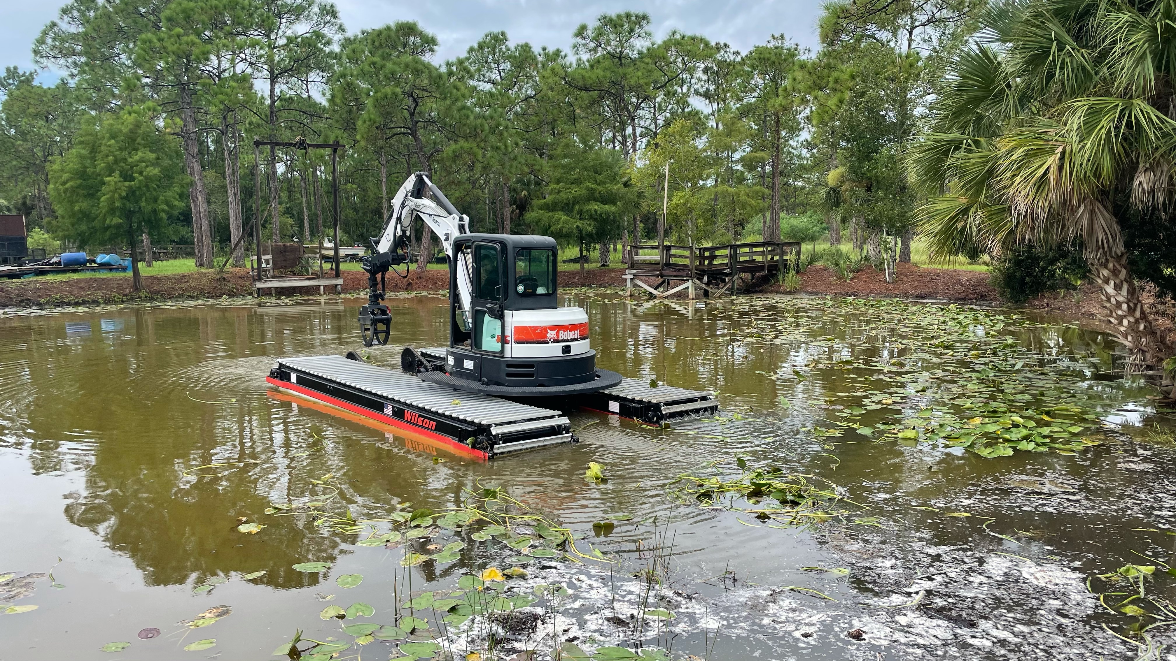 A Bobcat Amphibious Excavator operating in swampy conditions.